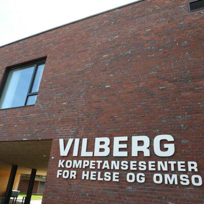 Exterior view of Vilberg Kompetansesenter for Helse og Omsorg, a healthcare and care competence center equipped with facilities including commercial laundry equipment like commercial tumble dryers and automatic ironing machines.