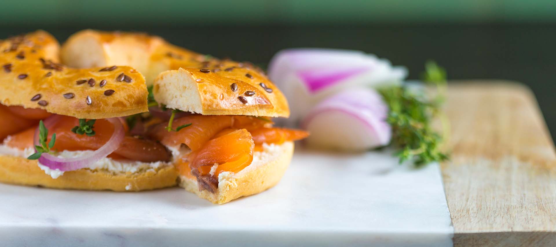 Delicious bagel with smoked salmon and cream cheese, served in a facility equipped with commercial laundry equipment, including commercial tumble dryers and automatic ironing machines.