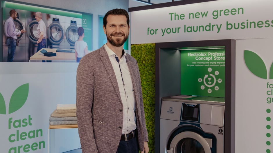 Executive presenting environmentally friendly commercial laundry machines