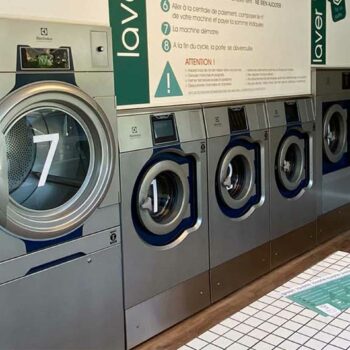 Modern commercial washer and dryer setup.